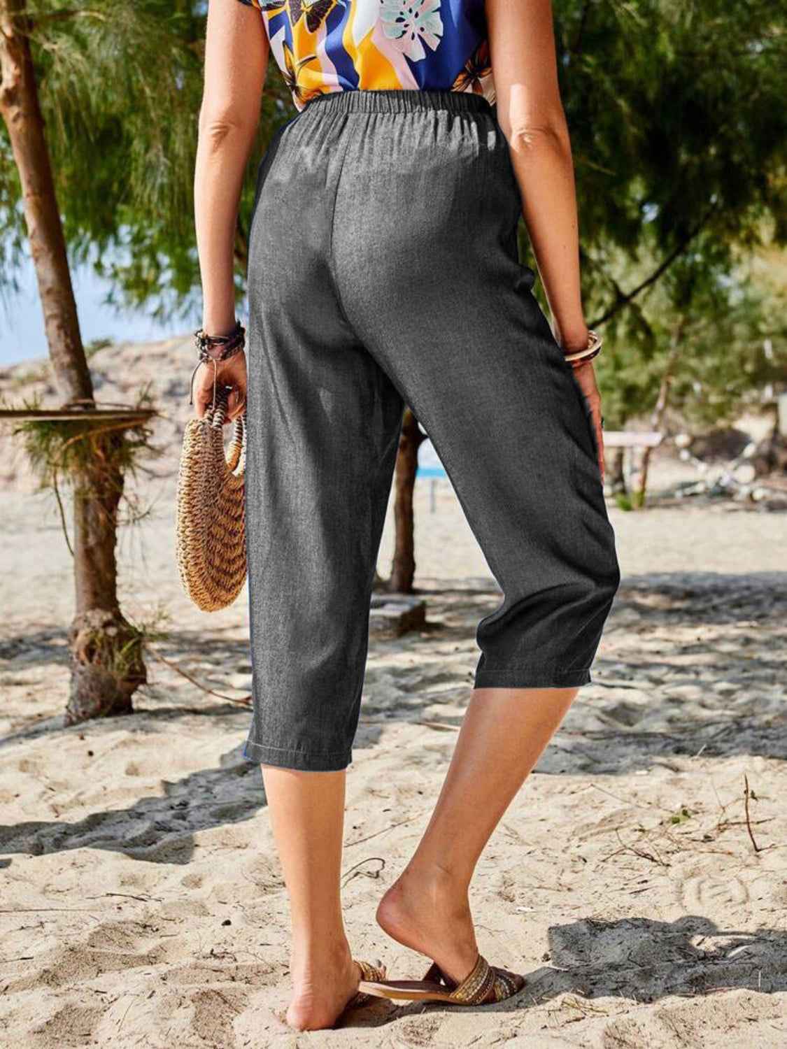 Back view of Women's Pocketed Elastic Waist Capris in dark gray, showcasing the elastic waistband and relaxed fit.