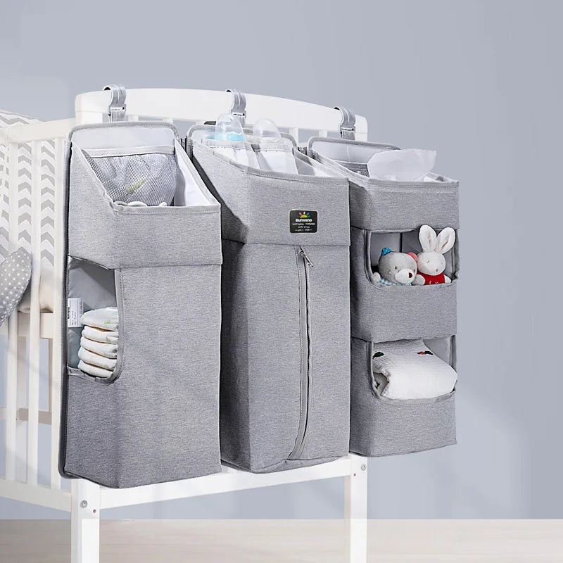 Sunveno Crib Organizer Baby Essentials Within Reach in a modern gray color, organized with diapers and plush toys, perfect for keeping baby items within easy reach.