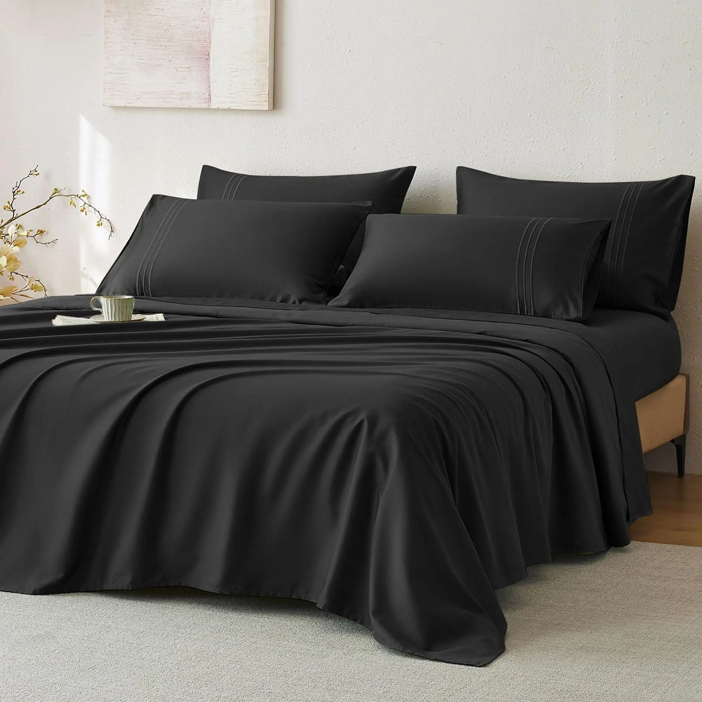 JELLYMONI Soft Cool Cotton Sateen Sheets displayed in an elegant black color, arranged on a bed with decorative pillows, perfect for a chic bedroom look.