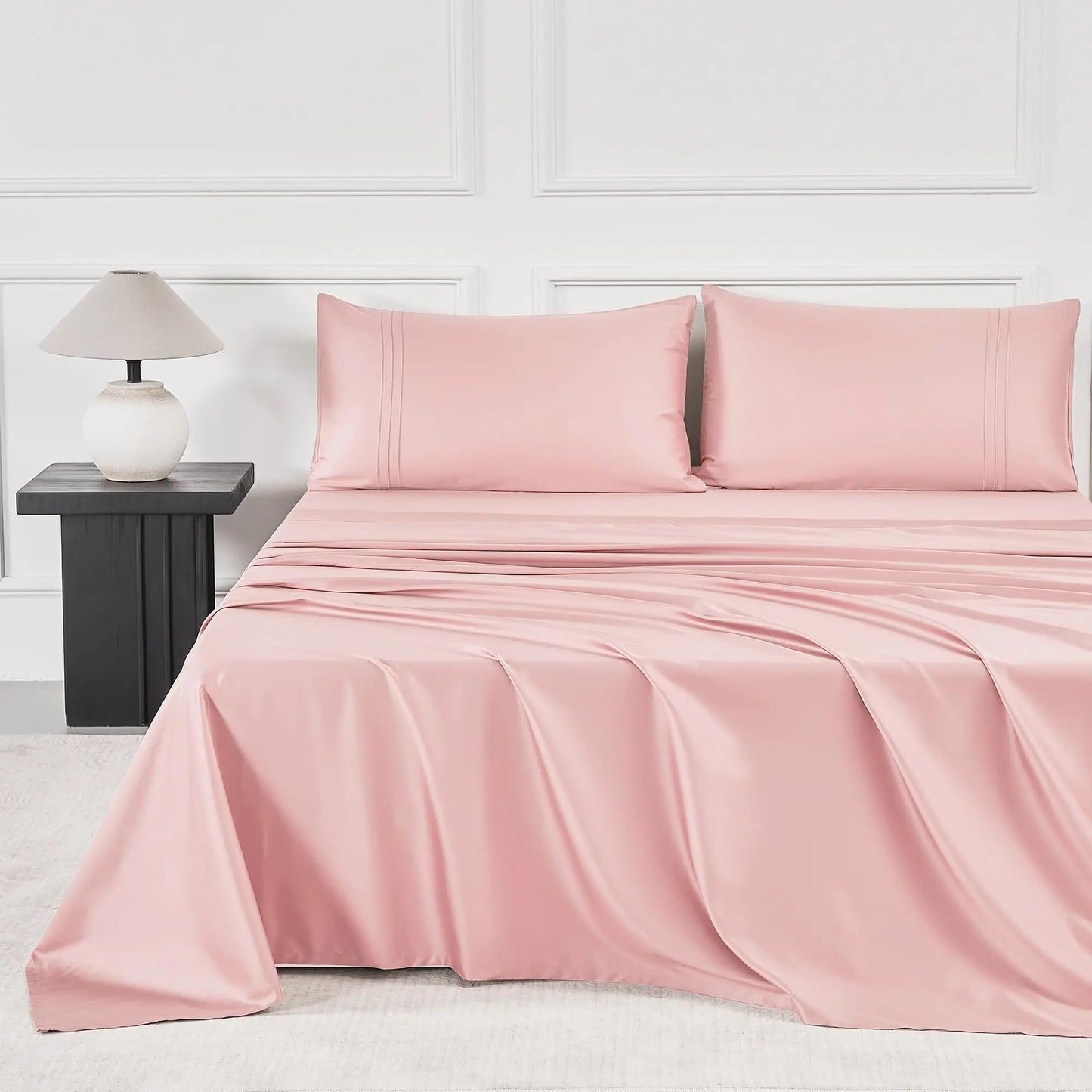 JELLYMONI Soft Cool Cotton Sateen Sheets featured in a soft pink color, showcasing a modern bed setup with matching pillowcases for a stylish and cozy atmosphere.
