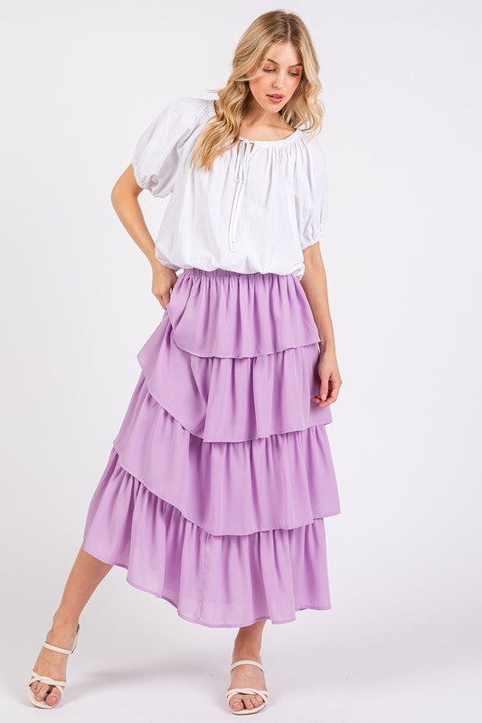 A model in the Mittoshop Chiffon Ruffle Layer Elastic Waist Midi Skirt from Zimonto, highlighting the skirt's layered ruffle design and comfortable fit, ideal for versatile styling. Explore this beautiful women's elastic waist skirt.