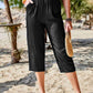 Women's Pocketed Elastic Waist Capris in black, perfect for a stylish yet comfortable look during warm weather.