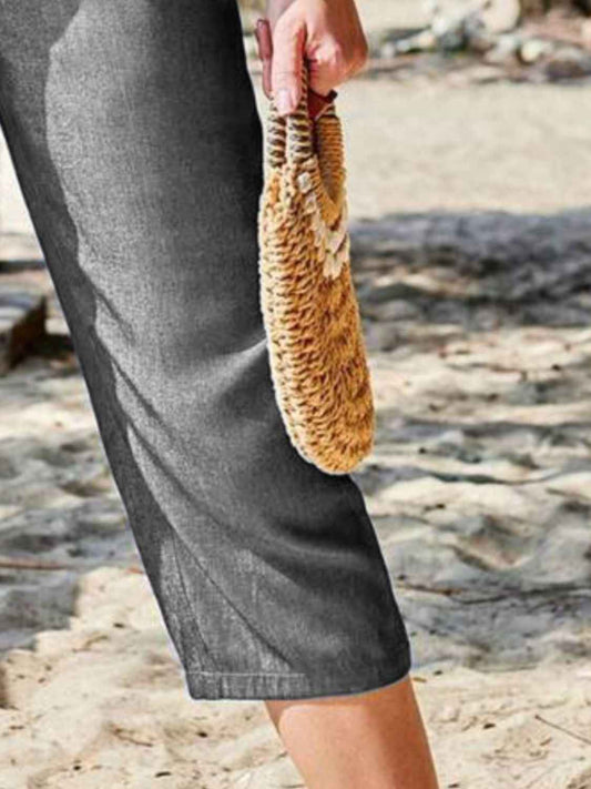 Close-up of Women's Pocketed Elastic Waist Capris in dark gray, focusing on the fabric texture and stylish pocket detail.