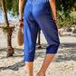 Back view of Women's Pocketed Elastic Waist Capris in blue, featuring an elastic waistband and comfortable design.