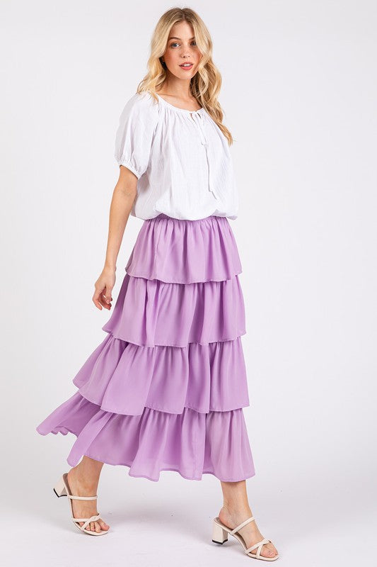 Model wearing the Mittoshop Chiffon Ruffle Layer Elastic Waist Midi Skirt in lavender, showcasing a flowy and stylish design, perfect for casual wear. Zimonto's women's elastic waist skirt features elegant cascading ruffles.
