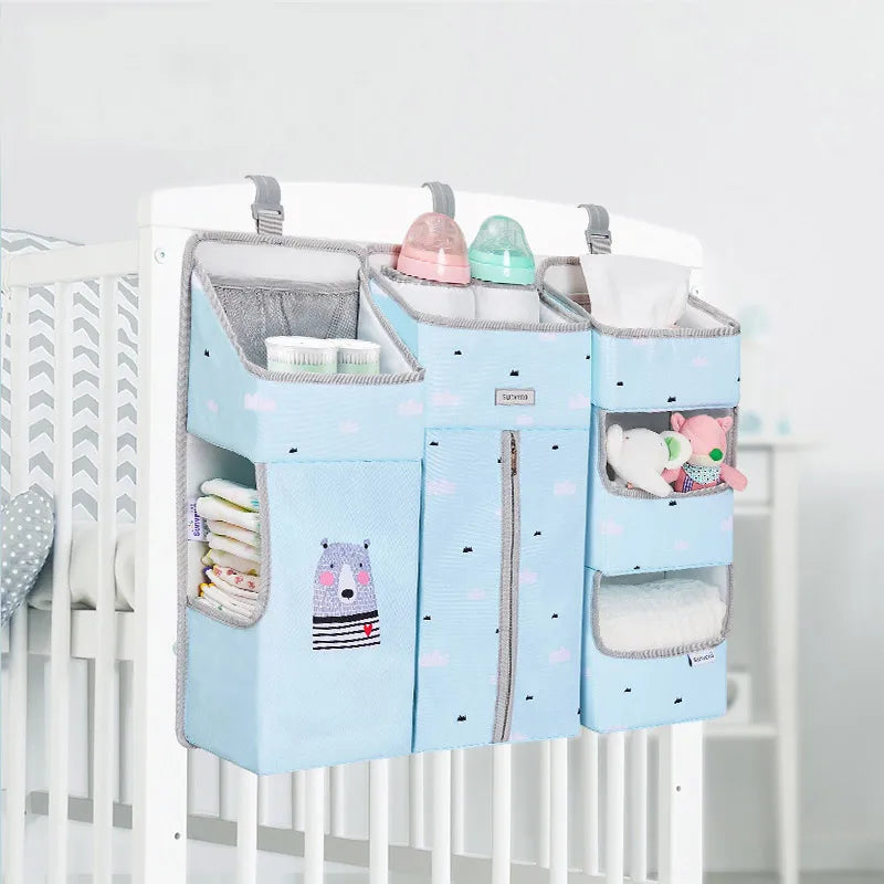 Sunveno Crib Organizer Baby Essentials Within Reach displayed on a crib, featuring accessible pockets for baby essentials including bottles and diapers, promoting easy access.
