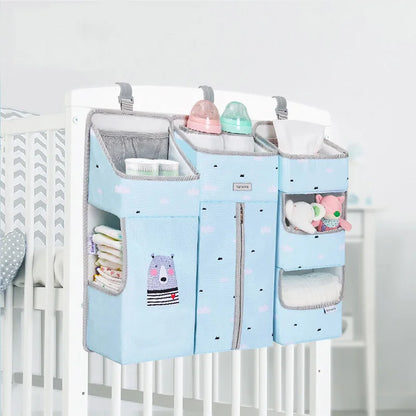 Sunveno Crib Organizer Baby Essentials Within Reach displayed on a crib, featuring accessible pockets for baby essentials including bottles and diapers, promoting easy access.