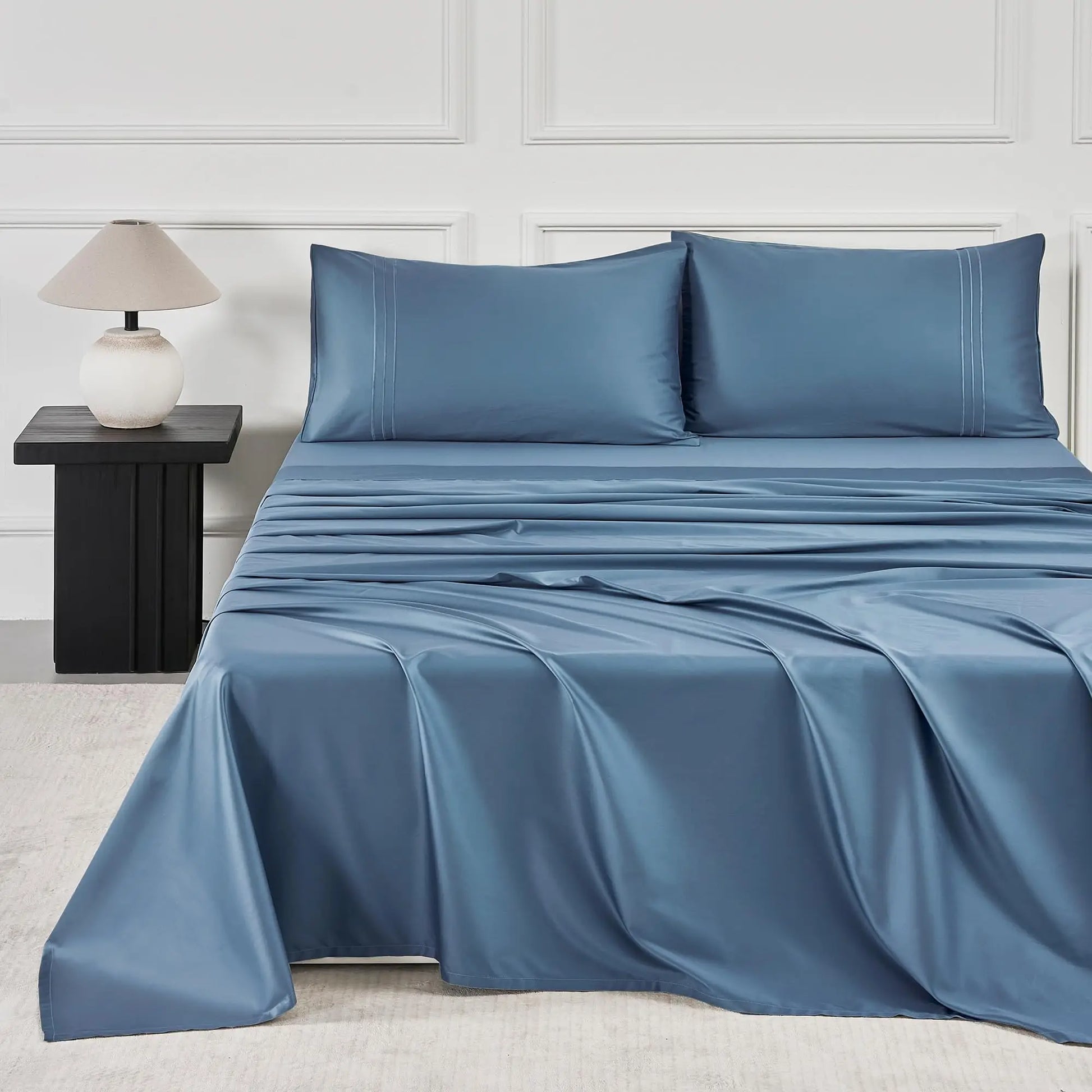 JELLYMONI Soft Cool Cotton Sateen Sheets in a calming light blue color, beautifully designed on a contemporary bed setup with matching pillows, creating a serene bedroom vibe.