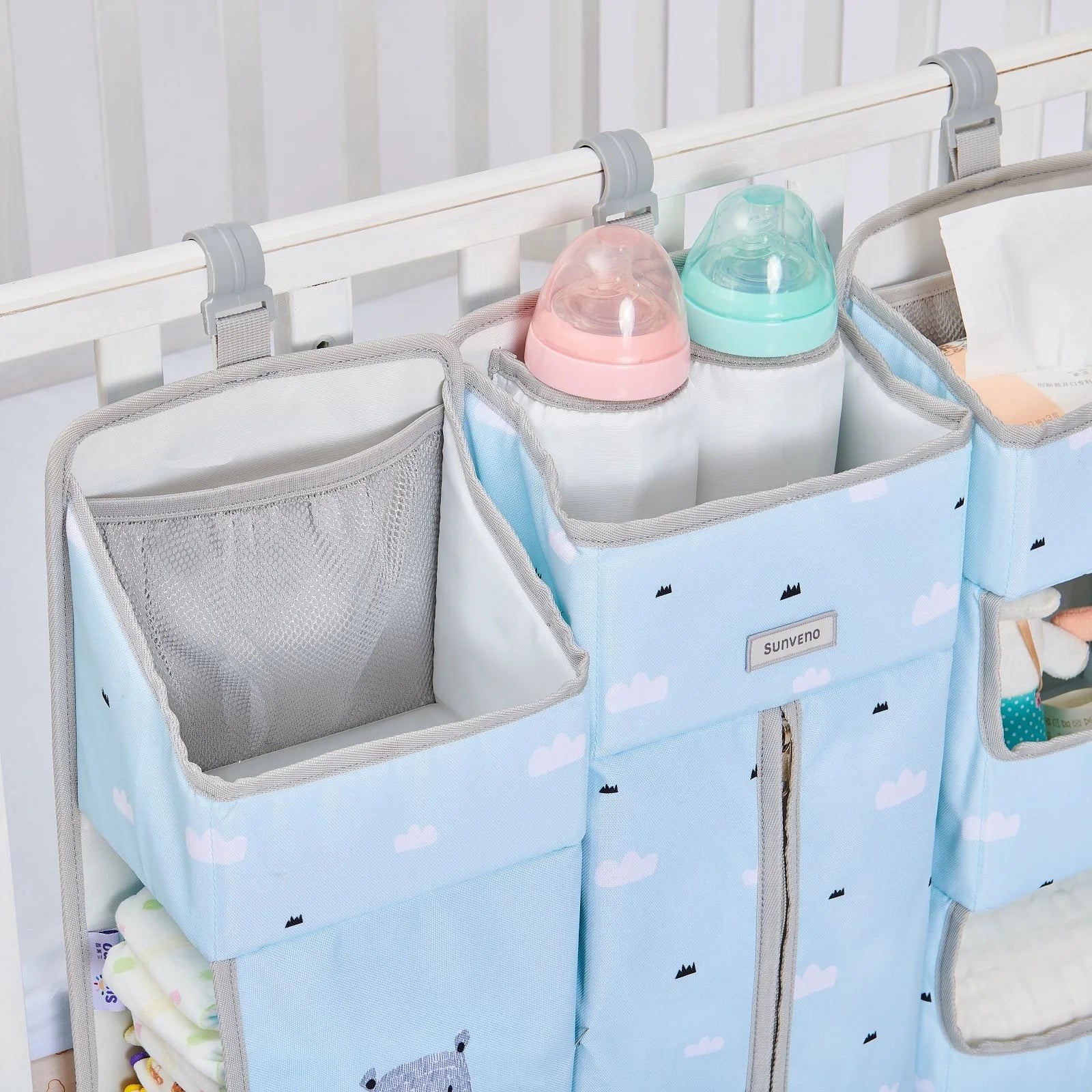 Close-up of the Sunveno Crib Organizer featuring bottles and neatly arranged baby essentials within easy reach.