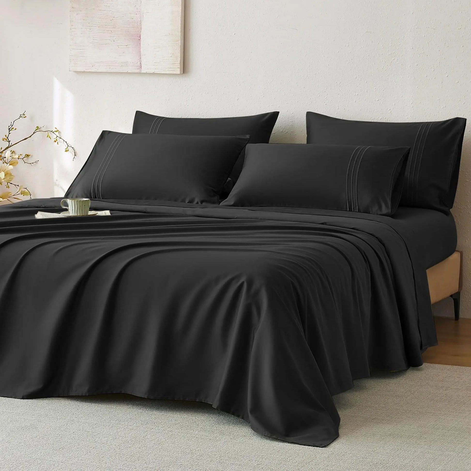 JELLYMONI Soft Cool Cotton Sateen Sheets displayed in an elegant black color, arranged on a bed with decorative pillows, perfect for a chic bedroom look.