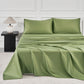 JELLYMONI Soft Cool Cotton Sateen Sheets beautifully arranged on a bed, showcasing a fresh green color alongside a bedside lamp for a cozy atmosphere.