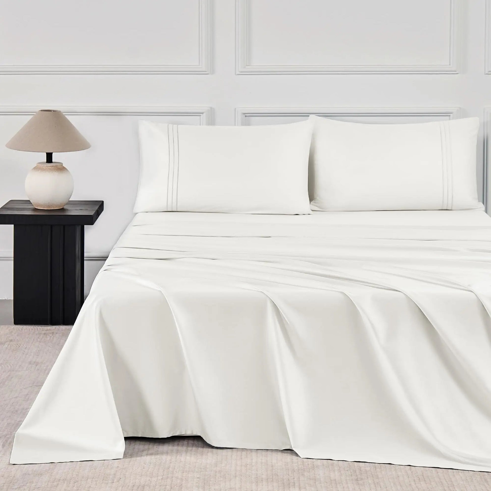 JELLYMONI Soft Cool Cotton Sateen Sheets in a crisp white color, elegantly styled on a modern bed with matching pillows, ideal for a fresh and clean bedroom aesthetic.