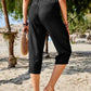 Back view of Women's Pocketed Elastic Waist Capris in black, showing the relaxed fit and elastic waistband.