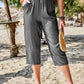 Women's Pocketed Elastic Waist Capris in dark gray, made from comfortable opaque fabric, perfect for casual beach outings.