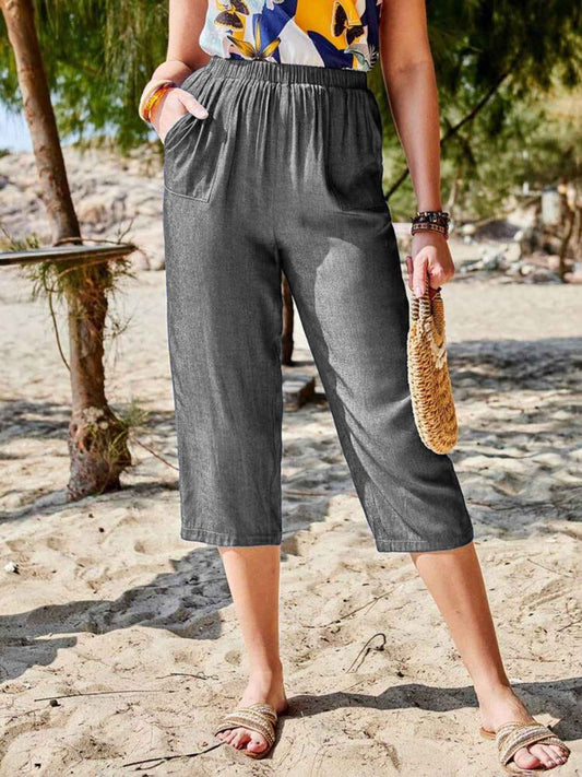 Women's Pocketed Elastic Waist Capris in dark gray, made from comfortable opaque fabric, perfect for casual beach outings.