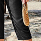 Close-up of Women's Pocketed Elastic Waist Capris in black, focusing on the pocket detail and soft fabric.