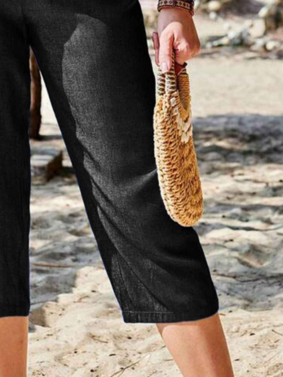 Close-up of Women's Pocketed Elastic Waist Capris in black, focusing on the pocket detail and soft fabric.