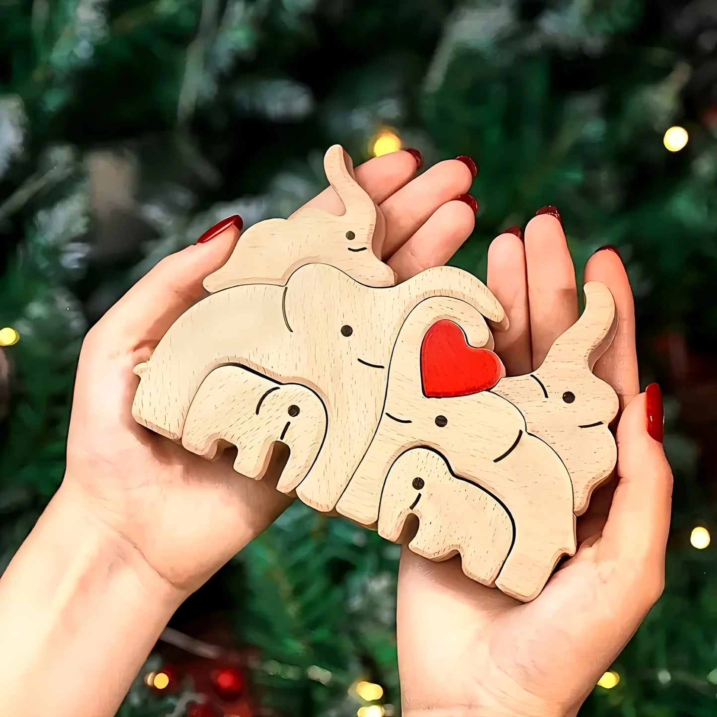 Personalized wooden elephant family sculpture held in hands, perfect for unique decor gifts