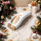 White and gold IPL hair remover device amidst snow, Christmas ornaments, and gift box in a festive holiday setting.
