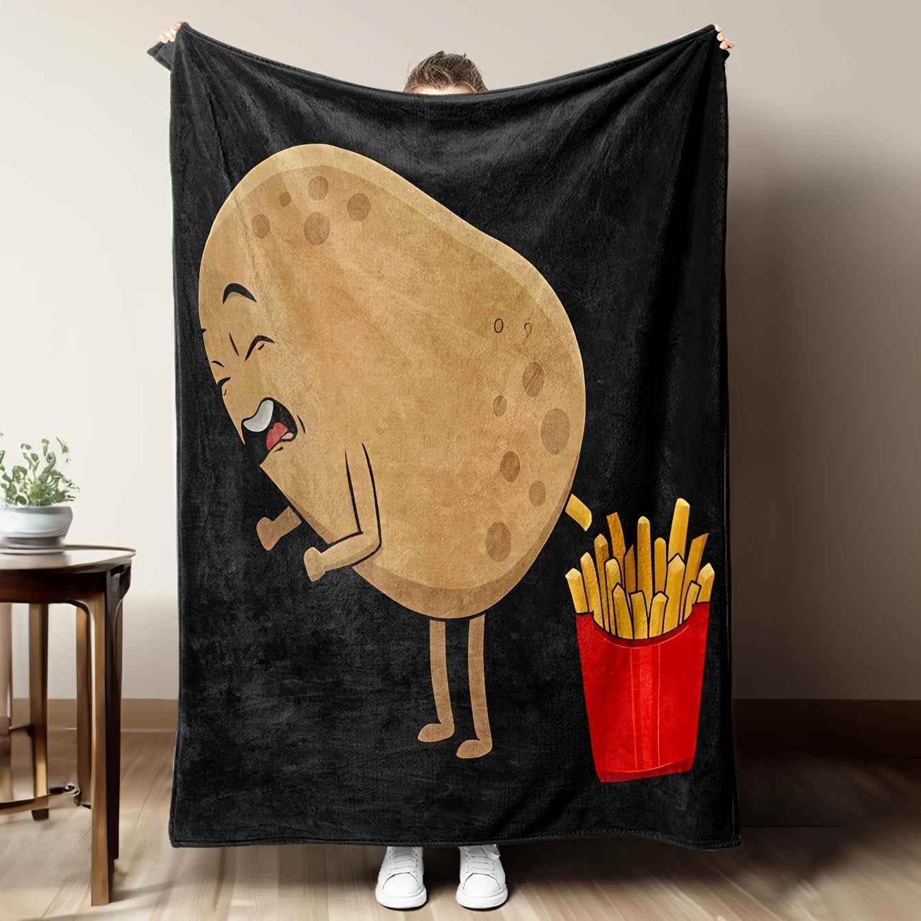 Whimsical French fry blanket featuring a cartoon potato and fries design for playful home decor